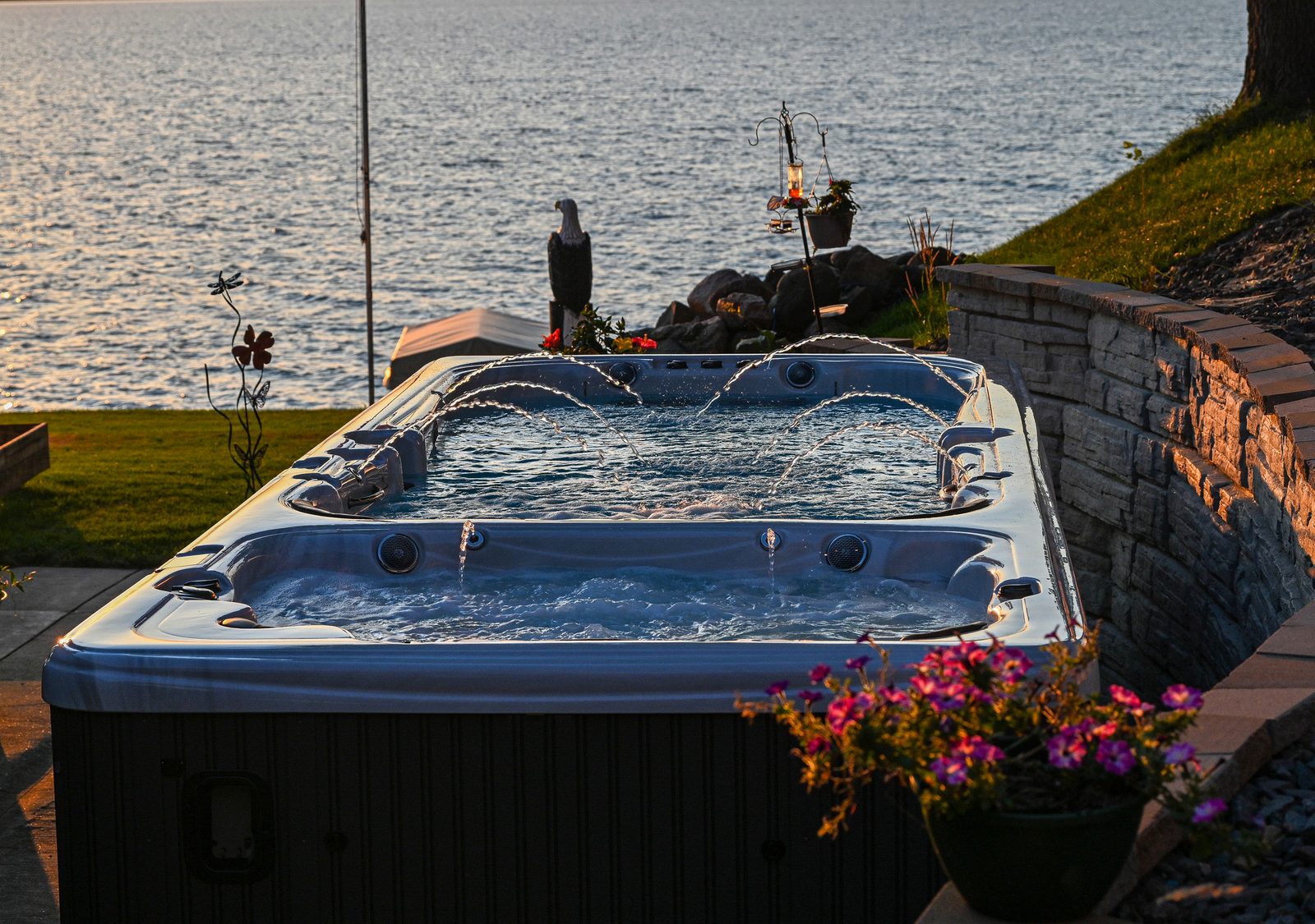 A Garden Leisure swim spa on a backyard patio at dusk